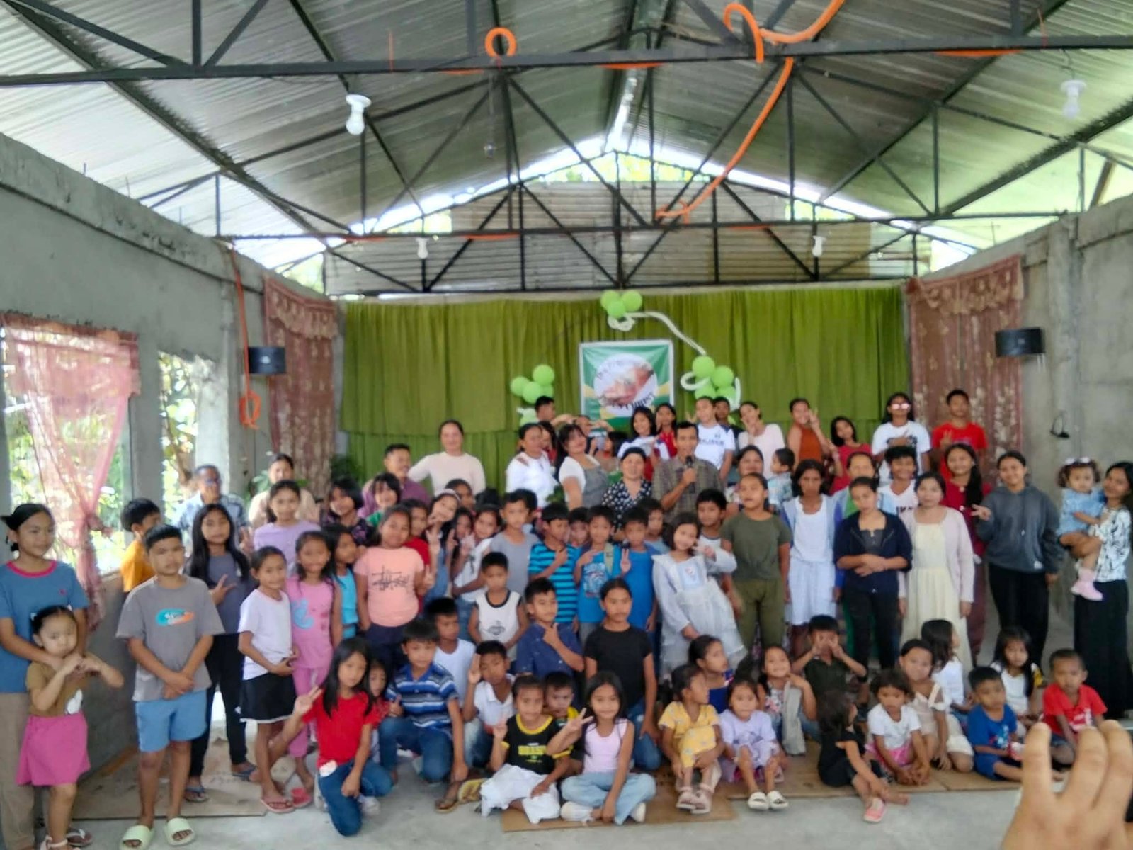 A large gathering of children and families celebrating together at the ministry's meeting place